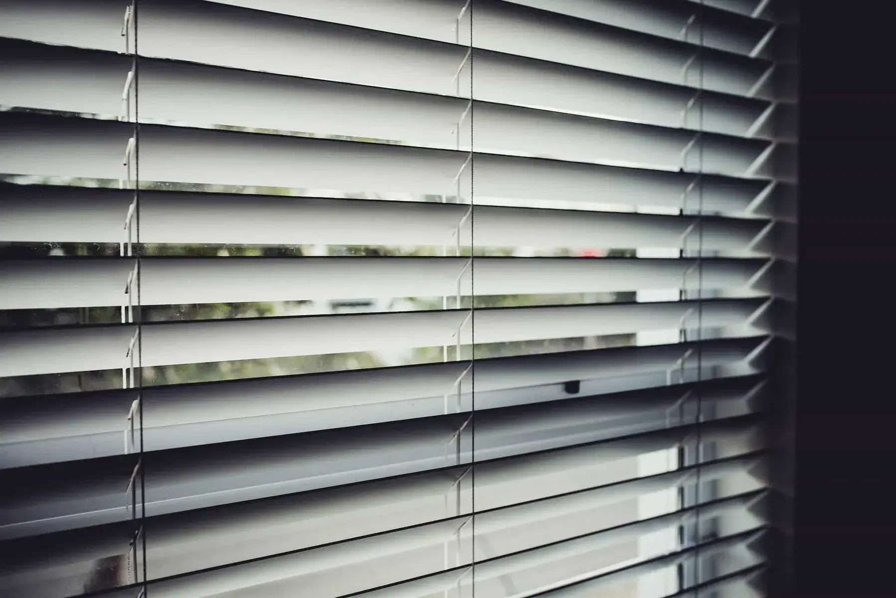The same window, now with elegant dark blinds controlling the light perfectly.