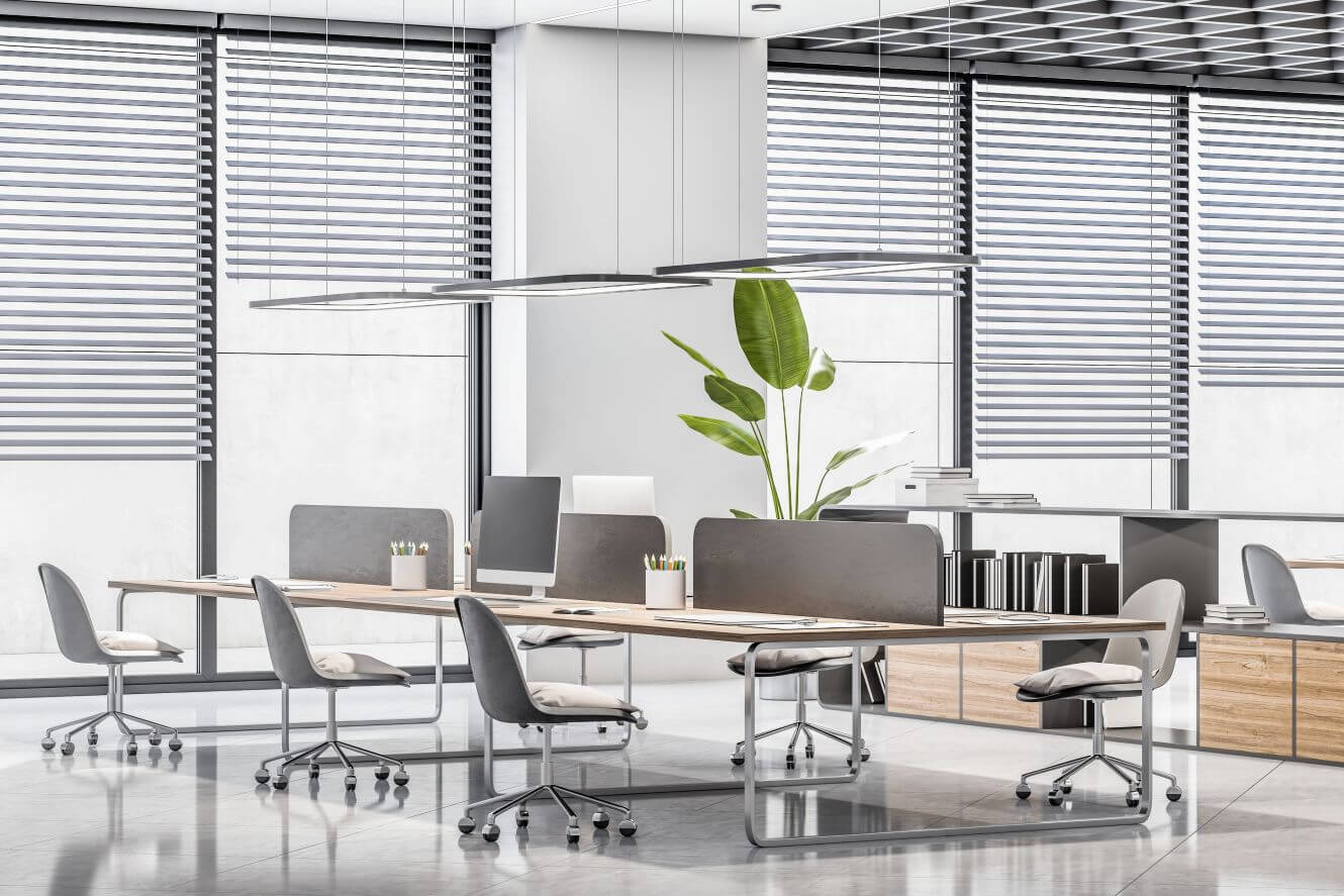 A bright and modern office with professional solar shades on the windows.