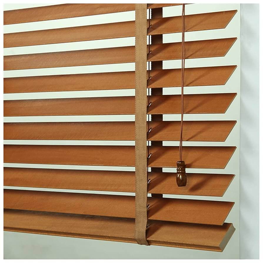 Moisture-resistant faux-wood venetian blinds in a bright, sunny kitchen.